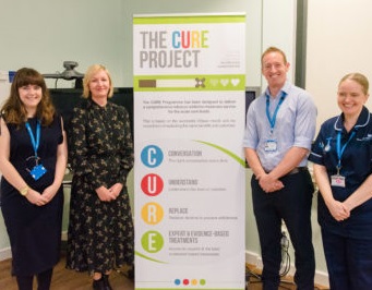 Image of CURE team with stand up banner
