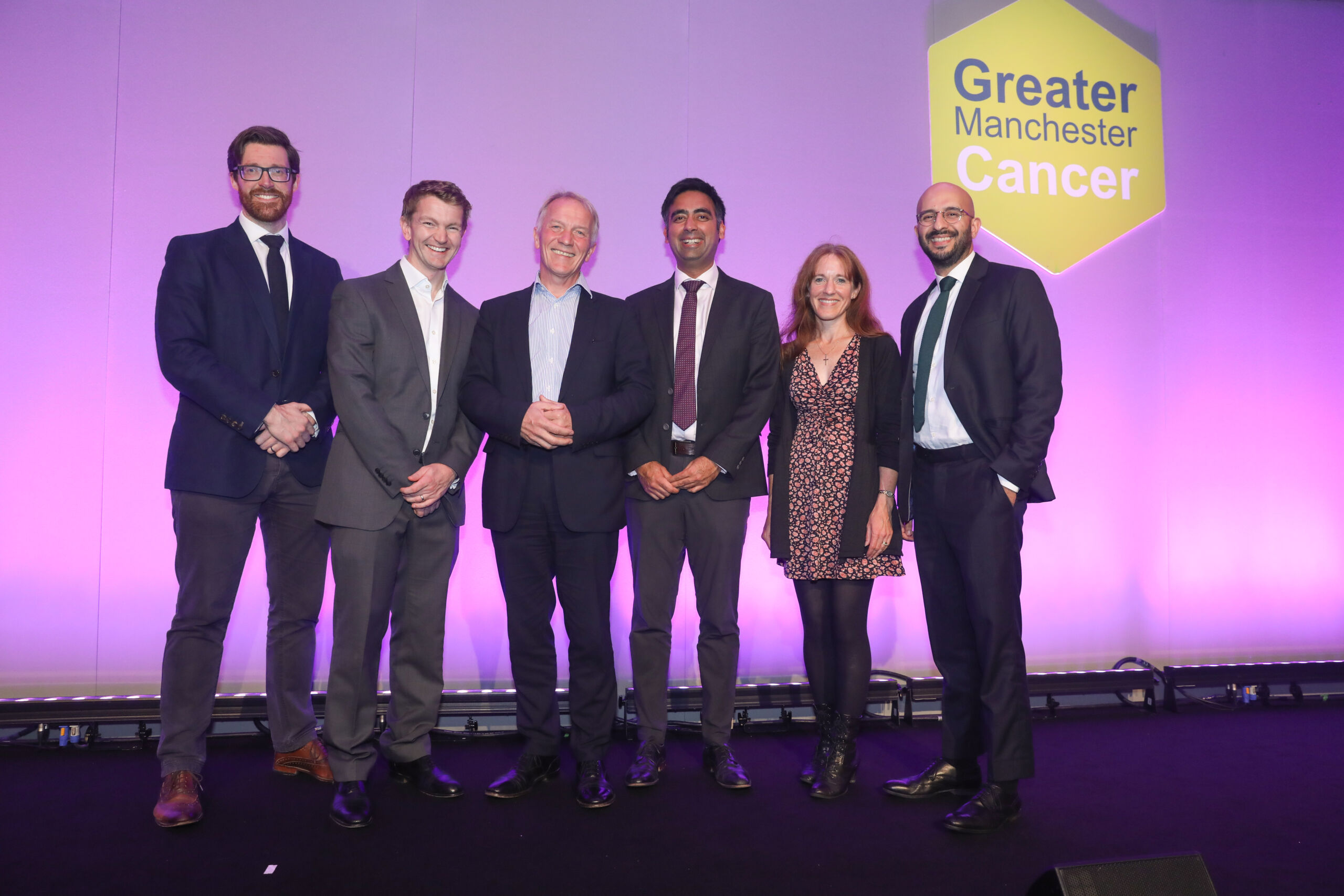 Guests at the GM Cancer Awards pose on stage