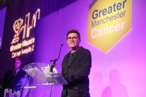 Andy Burnham on stage at the GM Cancer Awards