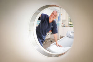 A radiographer looks inside a scanner on board the Targeted Lung Health Check
