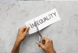 a pair of hands holding scissors, cutting the word "inequality" between the n and e