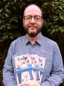 Image of David Jones-Stanley, author of Gulp holding his book.