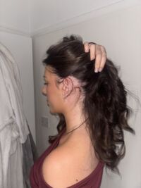 IMG_6803 A person pulling up their hair to show their neck