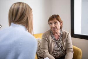 Senior woman during psychologist consultation An older white woman talking to a counsellor as part of NHS Talking Therapy