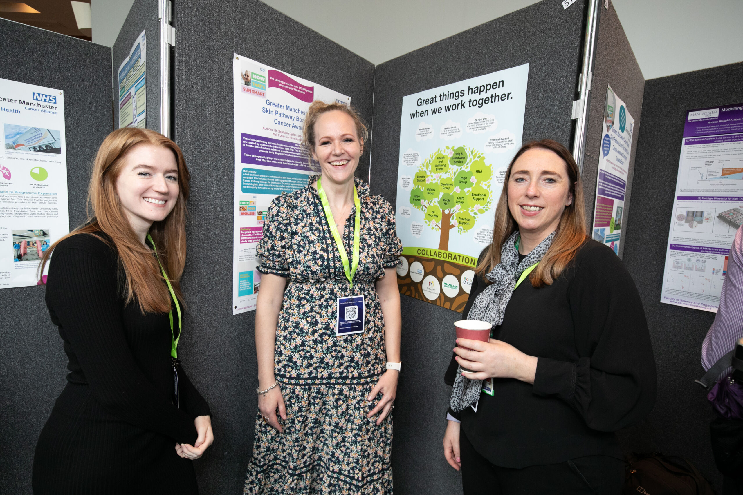 Three people standing in front of their poster display at the Greater Manchester Cancer Conference 2024