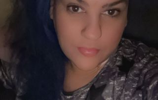 Photo of Siobhan Kennedy. She is a white woman with long dark hair and is looking at the camera.