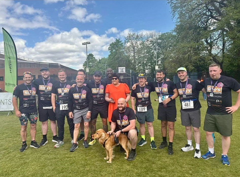 A group of people in sports wear about to start a triathlon