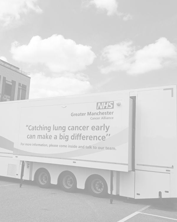 a black and white photo of the lung cancer screening truck in a carpark