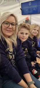 Alicia a white woman with blonde hair with her children all in matching jumpers