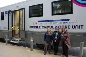 Mobile Cancer Care Unit – January 2026 (3) Three NHS staff stand in front of the new mobile cancer care unit for Greater Manchester