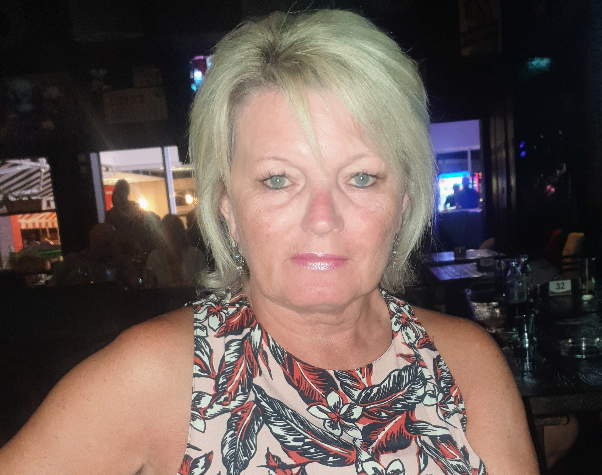 Sue, a white women with blonde hair and a short sleeve top