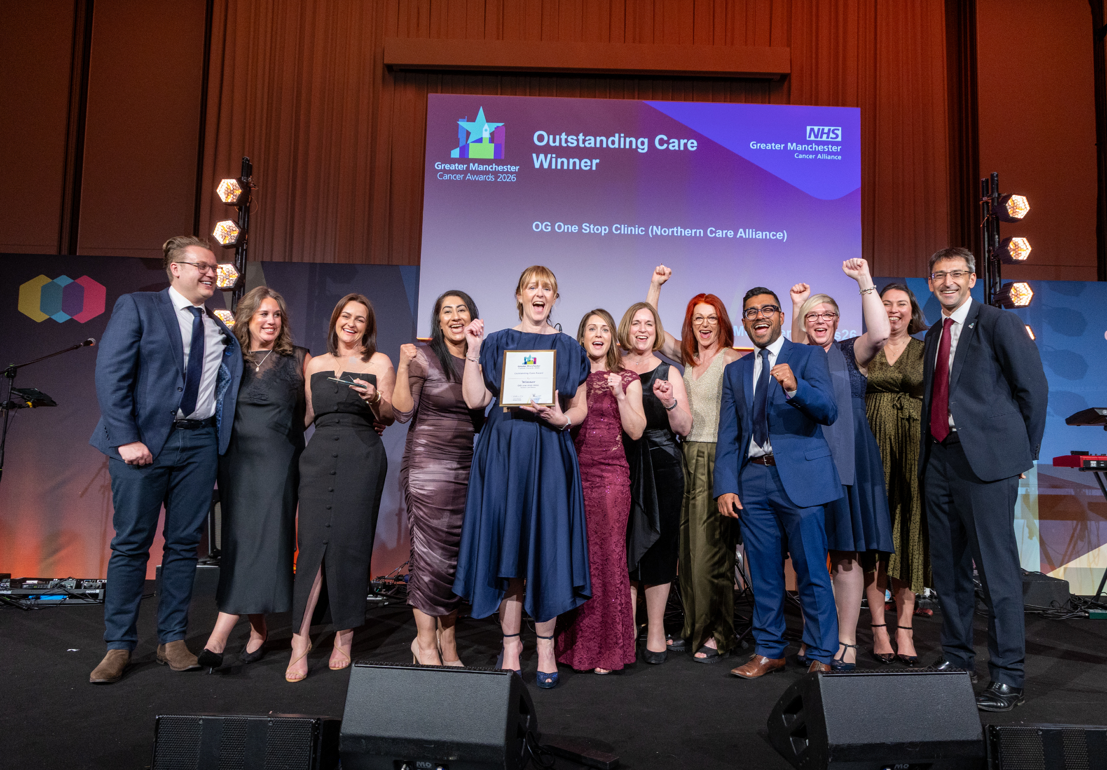 People on stage with an award