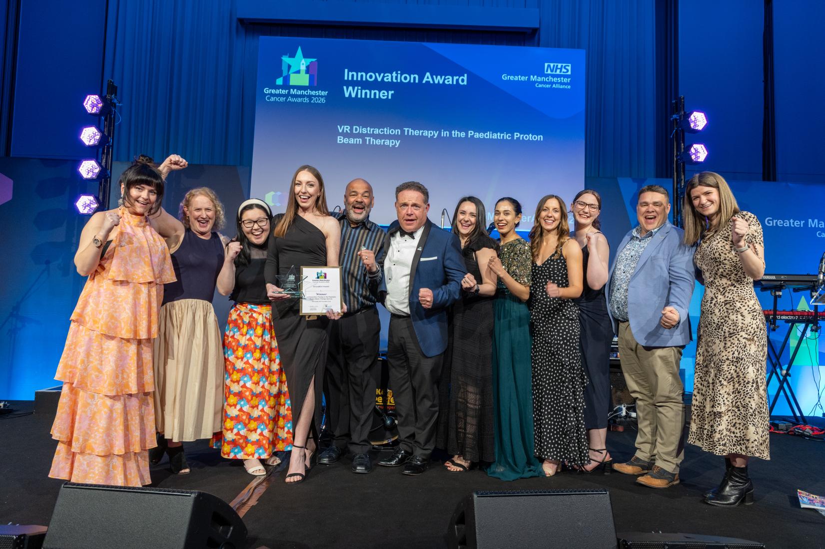 People on stage with an award