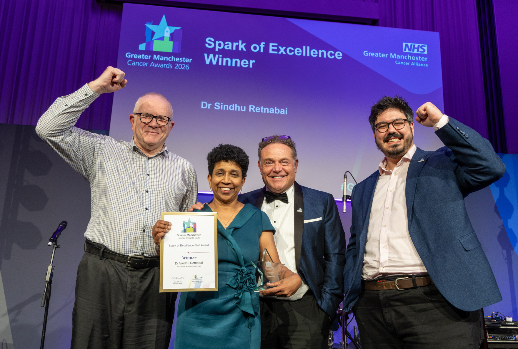 People on stage with an award