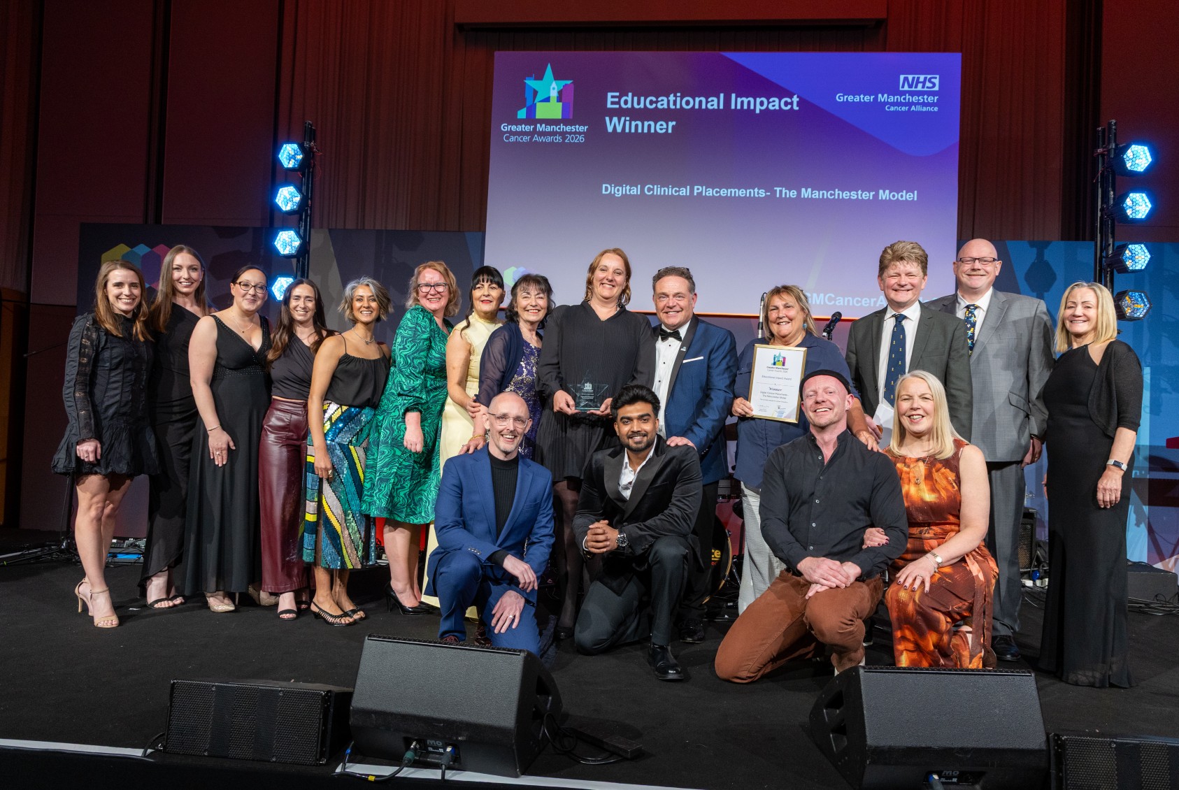 People on stage with an award
