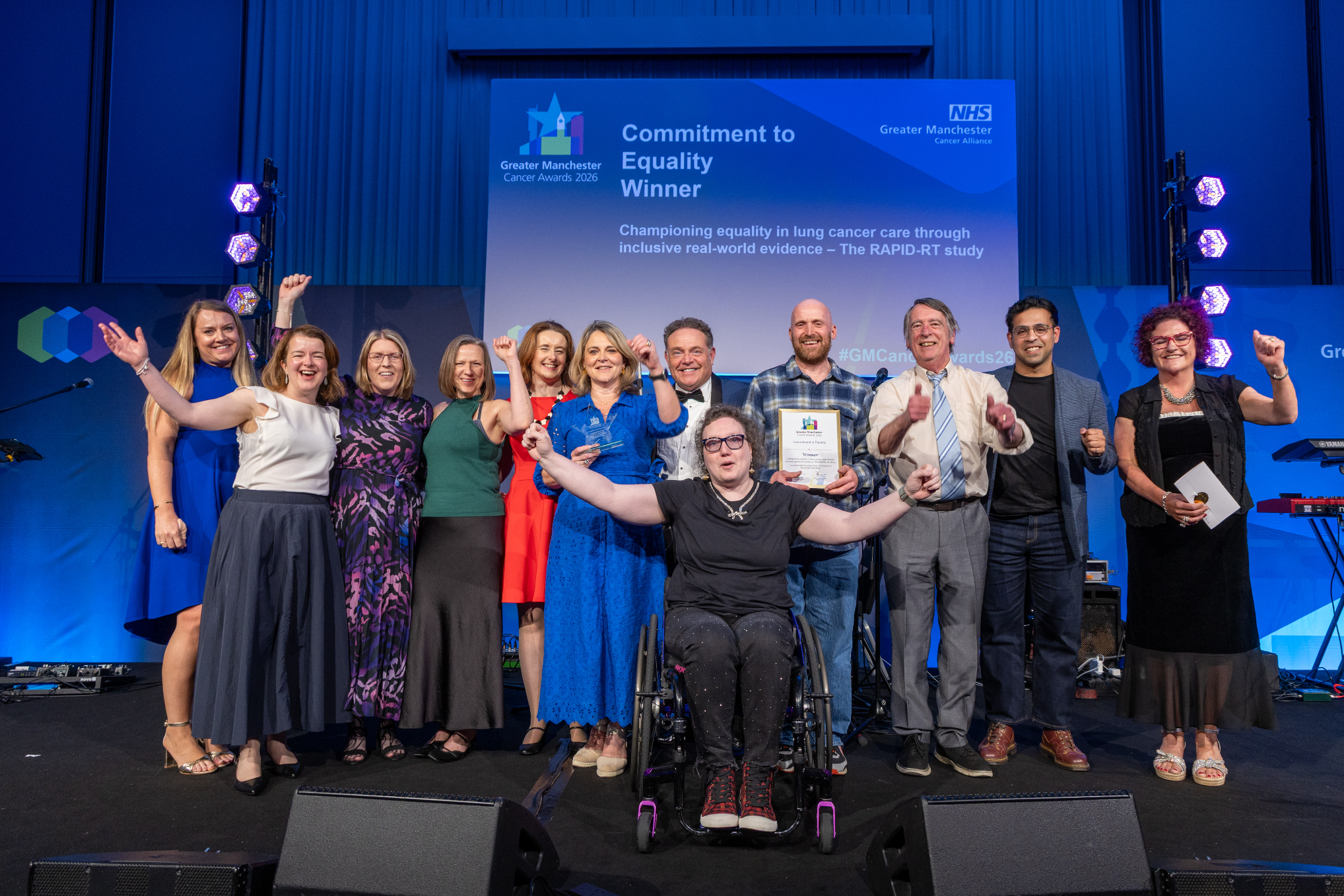 People on stage with an award