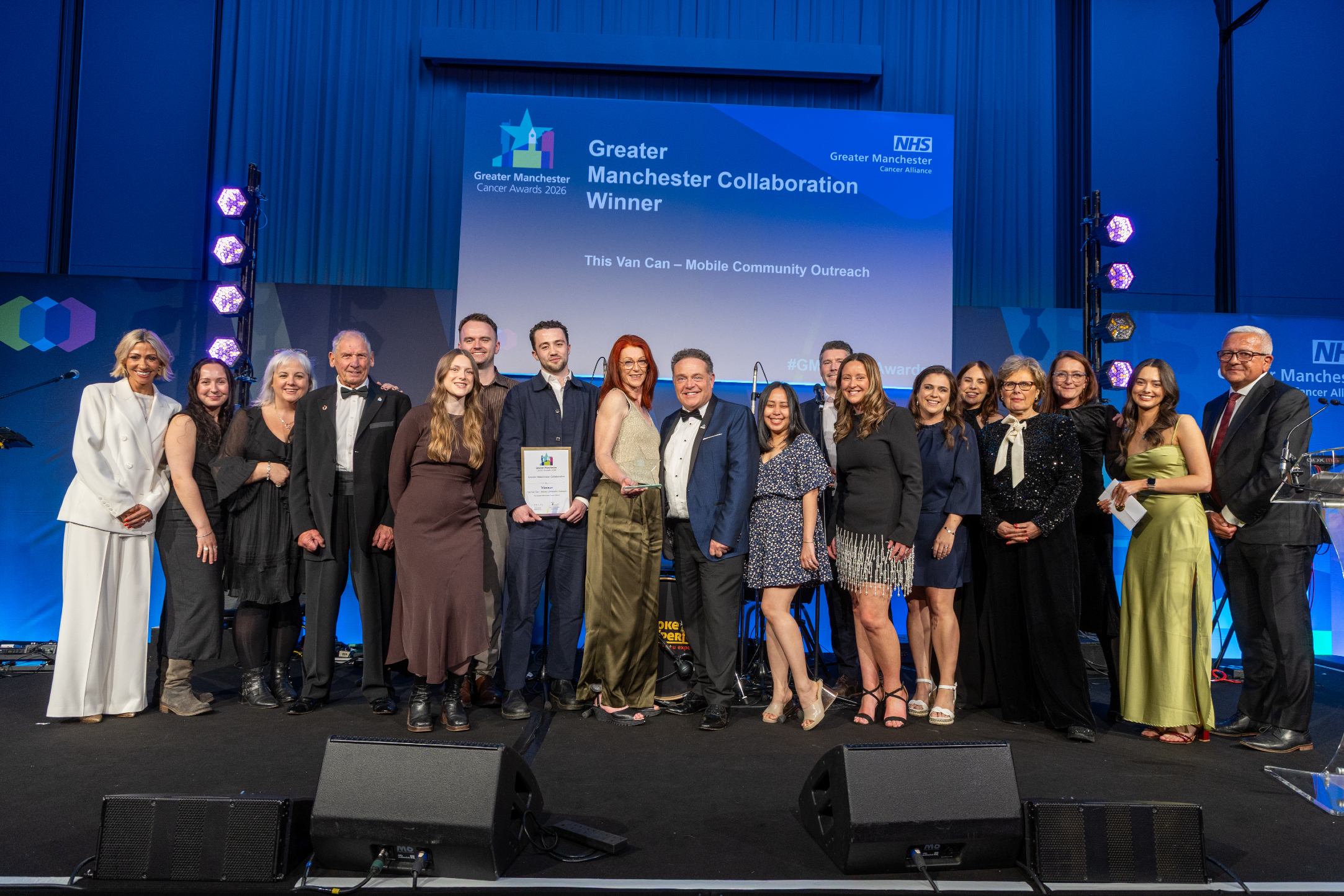 People on stage with an award