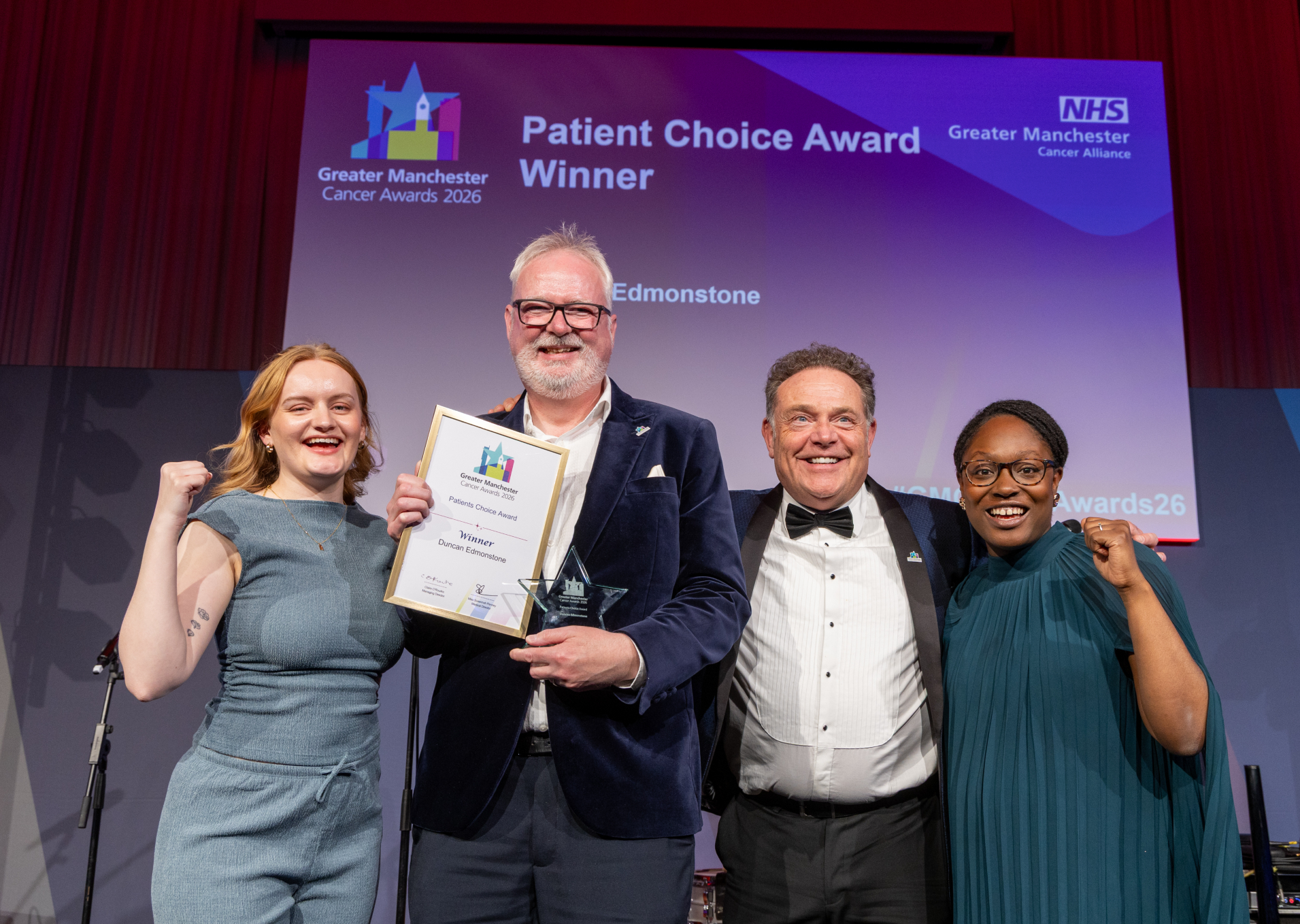 People on stage with an award