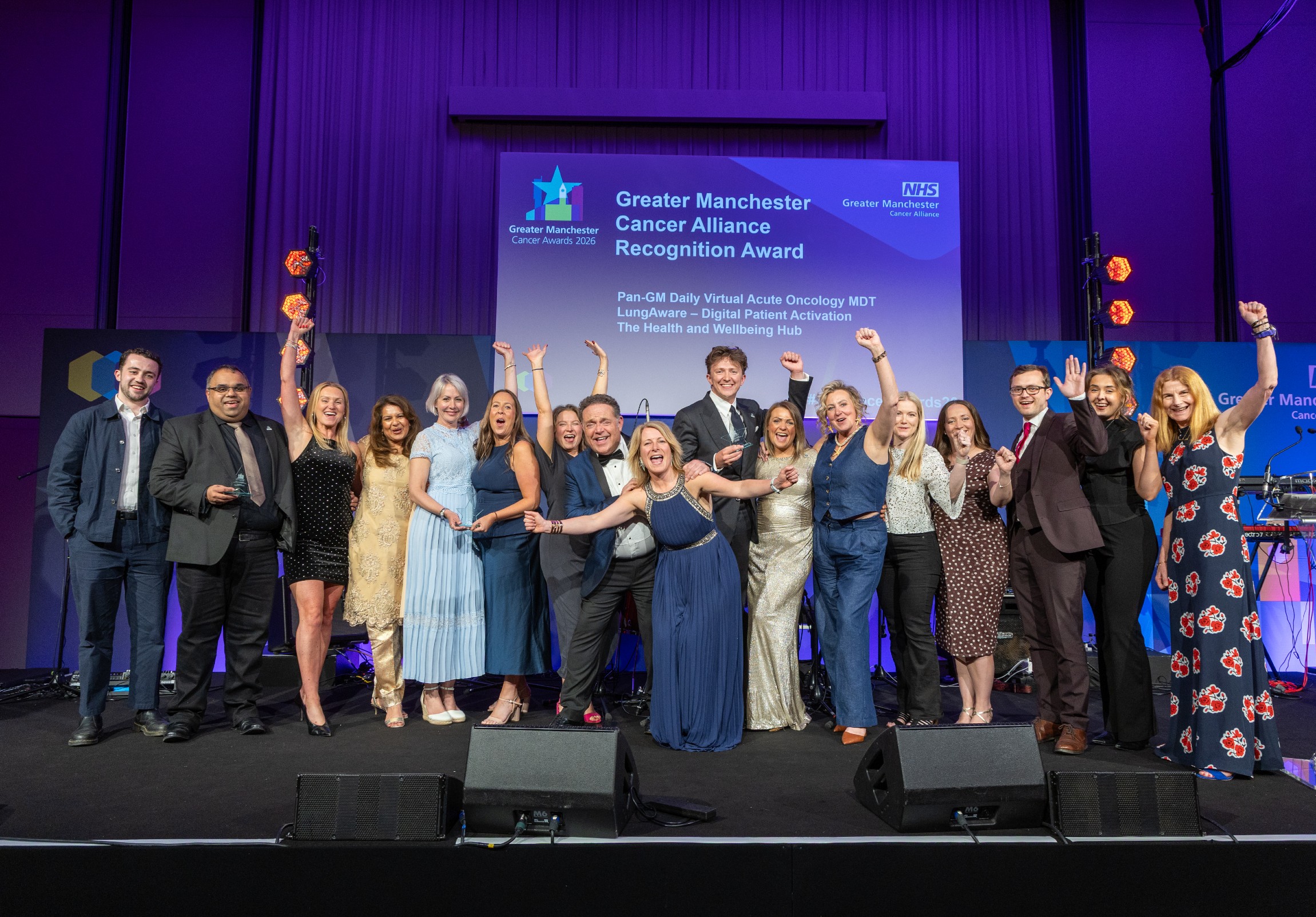 People on stage with an award