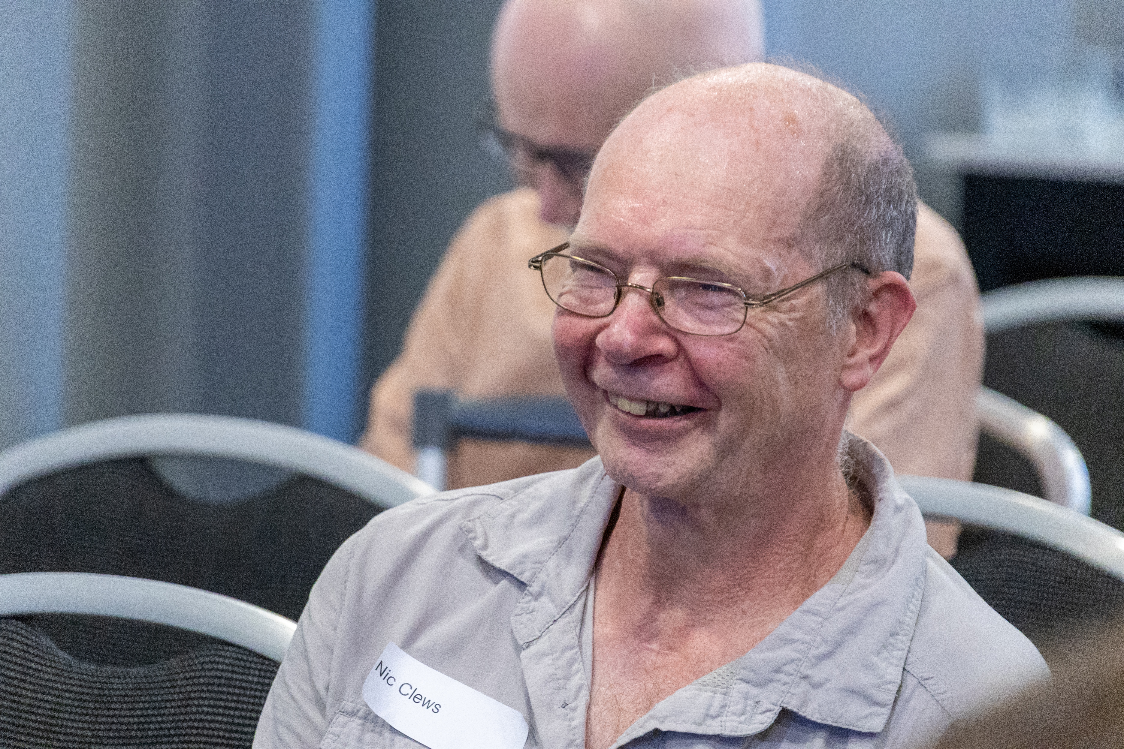 28 Close up of Nic Clews a patient representative sat in the audience of a conference smiling