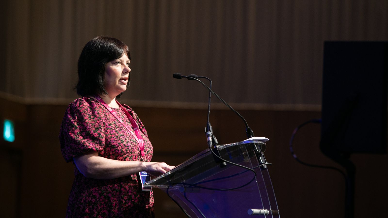 Kathy Morse on stage at the Greater Manchester Cancer Conference sharing her story to delegates