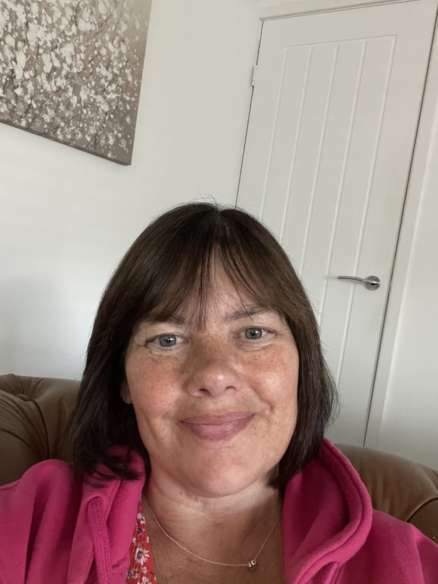 A selfie of Kathy Morse, 59, from Walkden, Salford smiling at the camera with a pink fleece on.
